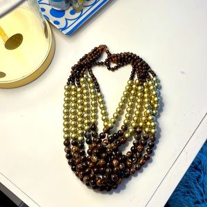 Brown and gold necklace with knot at center